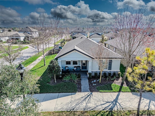 view of front of property featuring a front yard and covered porch