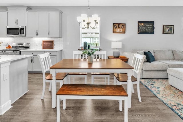 dining area featuring an inviting chandelier and wood-type flooring