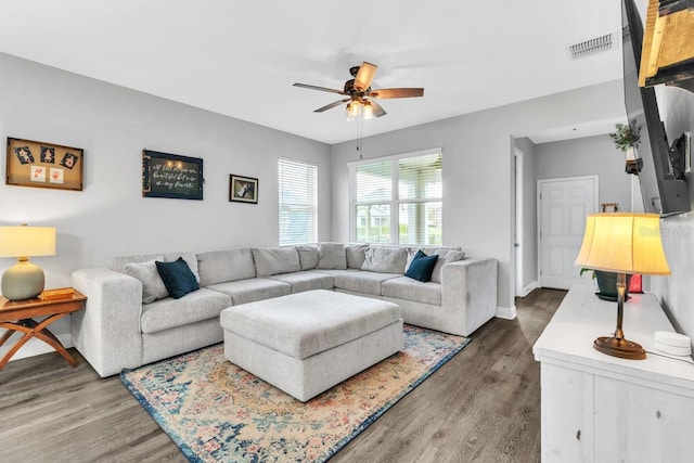 living room with ceiling fan and dark hardwood / wood-style flooring