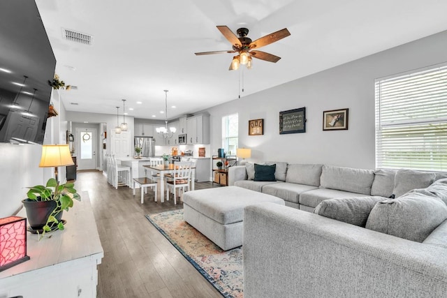 living room with hardwood / wood-style flooring and ceiling fan