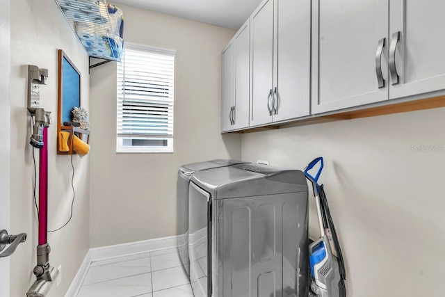 washroom featuring cabinets and independent washer and dryer