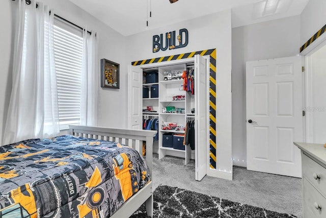 carpeted bedroom featuring multiple windows and a closet