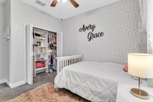 bedroom with ceiling fan, dark carpet, and a closet