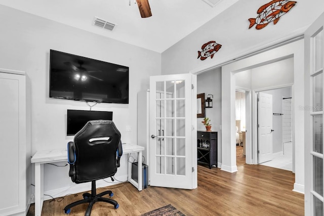 office with french doors, ceiling fan, and light hardwood / wood-style flooring