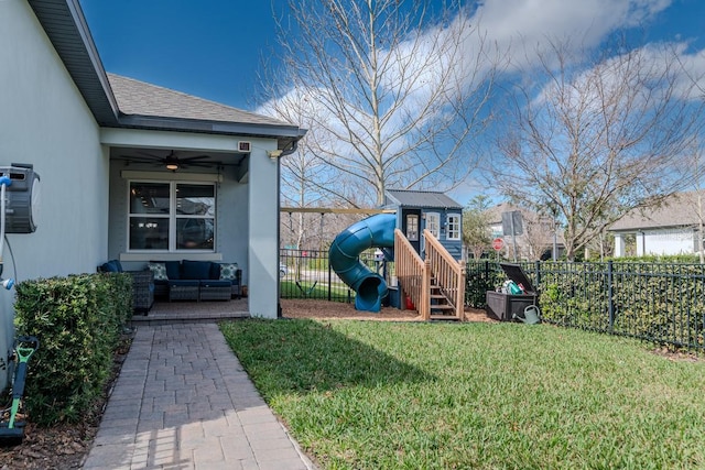 view of yard featuring ceiling fan, outdoor lounge area, and a playground