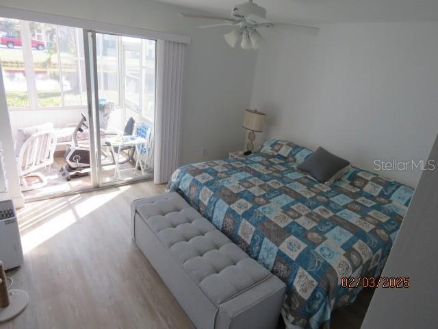 bedroom featuring access to exterior, ceiling fan, and light wood-type flooring