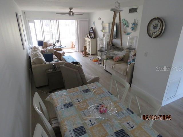 living room featuring ceiling fan and hardwood / wood-style floors