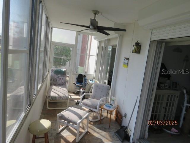 sunroom / solarium with ceiling fan