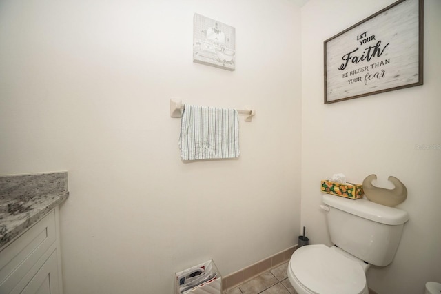 bathroom with baseboards, vanity, toilet, and tile patterned floors