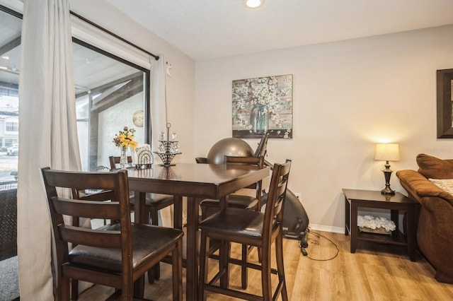 dining room featuring baseboards and wood finished floors