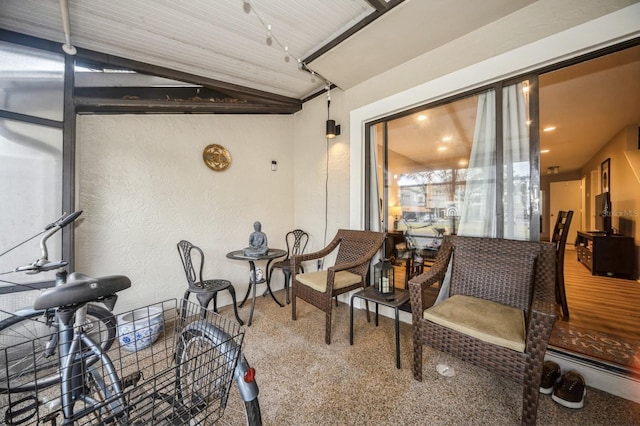 sunroom / solarium featuring vaulted ceiling