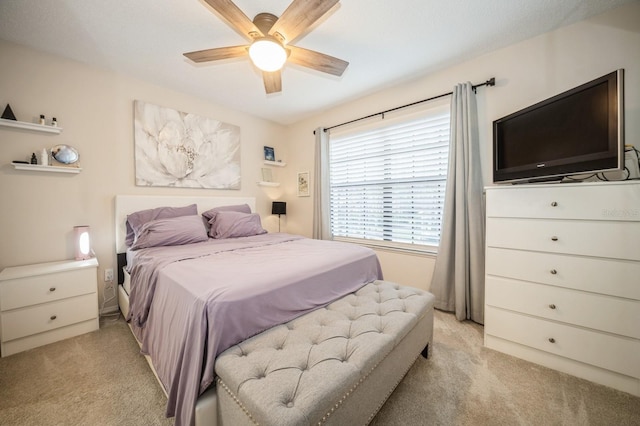 bedroom with light carpet and ceiling fan