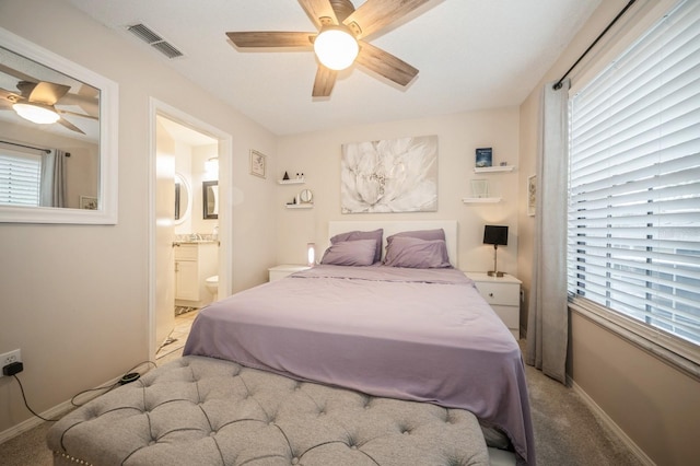 carpeted bedroom featuring a ceiling fan, visible vents, baseboards, and multiple windows