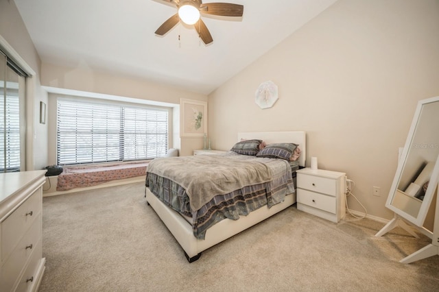 bedroom featuring lofted ceiling, ceiling fan, baseboards, and light colored carpet