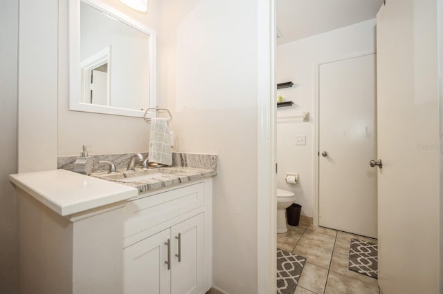 bathroom with vanity, toilet, and tile patterned floors