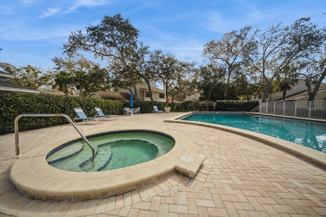 pool featuring fence, a community hot tub, and a patio