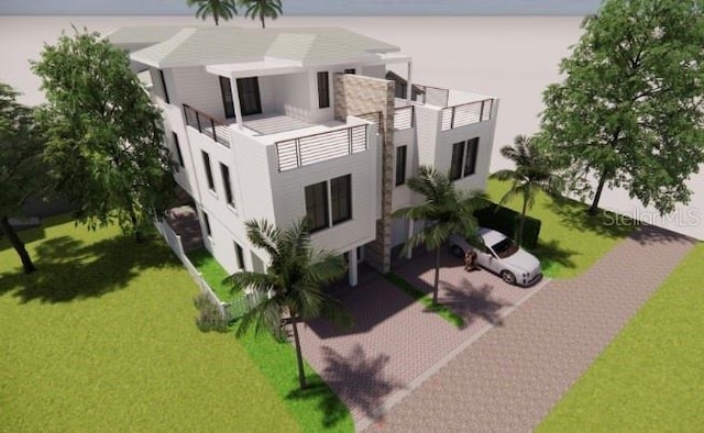 exterior space featuring a balcony, stucco siding, and a front yard