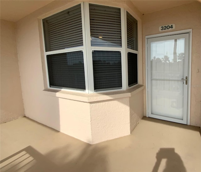 property entrance featuring stucco siding