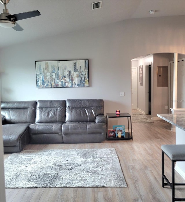 living room featuring vaulted ceiling, ceiling fan, and light hardwood / wood-style flooring