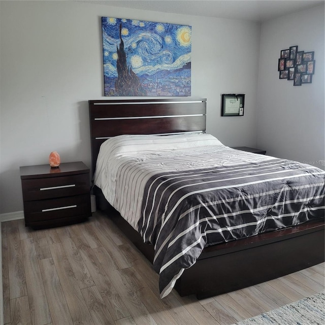 bedroom with hardwood / wood-style flooring