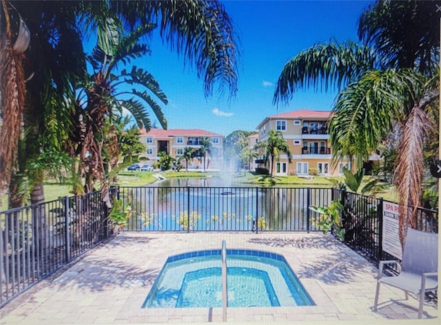 view of swimming pool with a water view