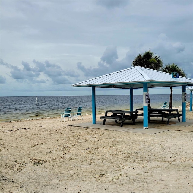 view of home's community featuring a gazebo, a beach view, and a water view