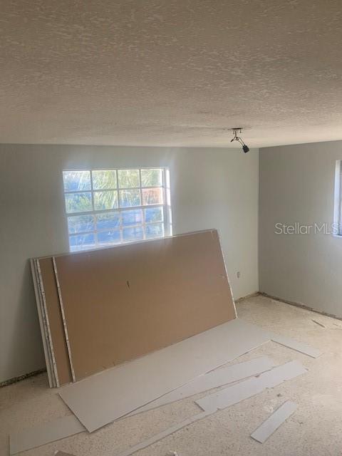 unfurnished room featuring a textured ceiling