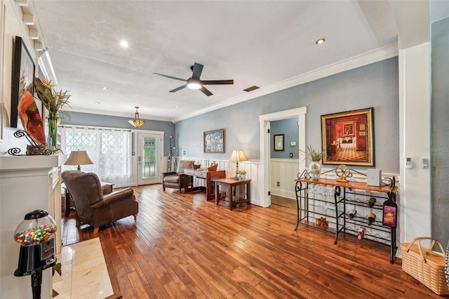 living room featuring ornamental molding, hardwood / wood-style floors, and ceiling fan