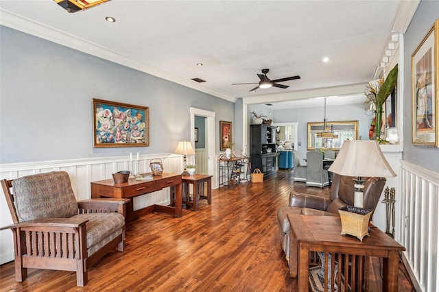 living room with crown molding, ceiling fan, and wood-type flooring