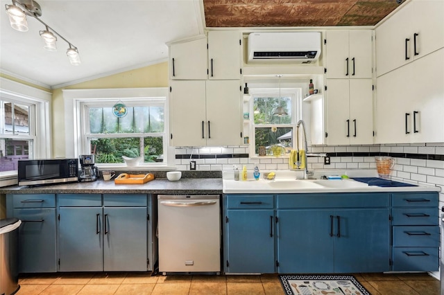 kitchen with tasteful backsplash, dishwasher, lofted ceiling, sink, and a healthy amount of sunlight