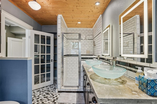 bathroom with wood ceiling, vanity, and a shower with door