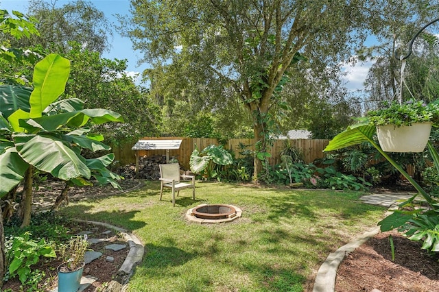 view of yard with a fire pit