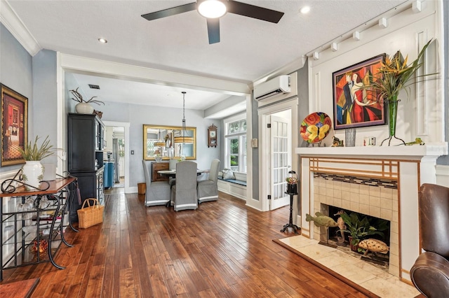 dining space featuring crown molding, dark wood-type flooring, ceiling fan, a fireplace, and an AC wall unit