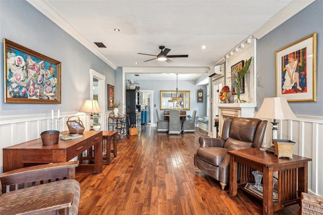 living room featuring dark hardwood / wood-style flooring, a wall mounted air conditioner, crown molding, and ceiling fan