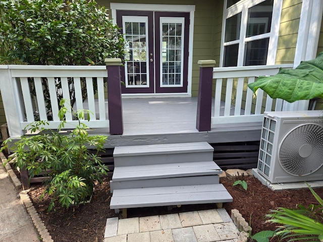 deck featuring ac unit and french doors