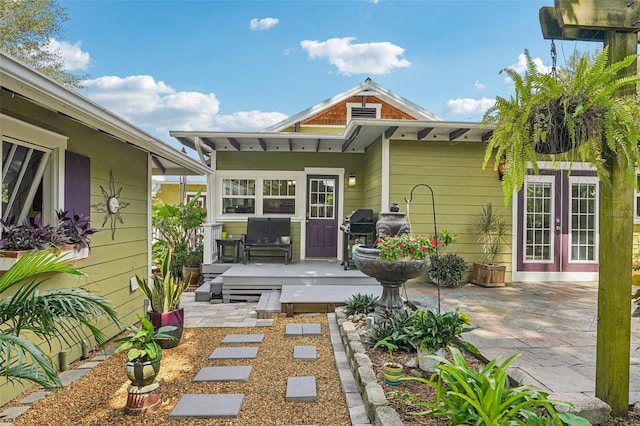 back of property with a patio and french doors