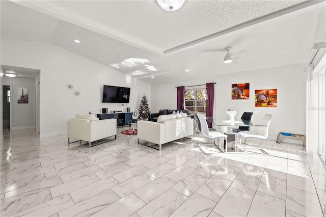 living room with lofted ceiling, ceiling fan, and a textured ceiling