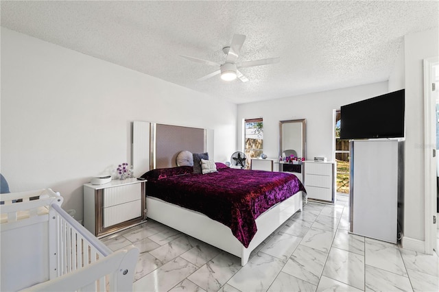 bedroom with a textured ceiling and ceiling fan