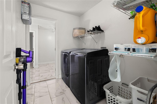 washroom featuring washer and clothes dryer and a textured ceiling