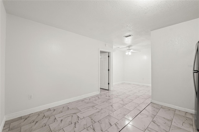 unfurnished room featuring a textured ceiling and ceiling fan