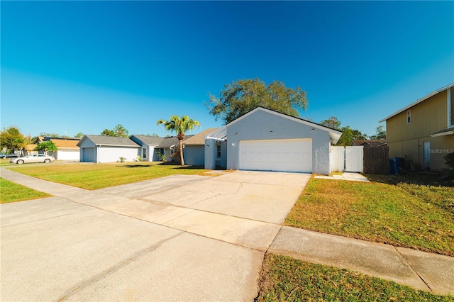 ranch-style house featuring a front yard and a garage