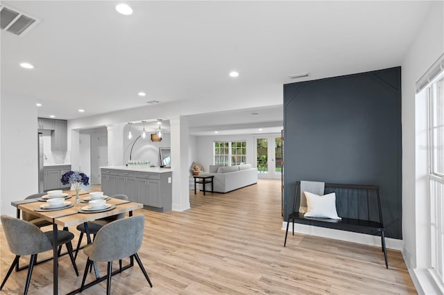 dining room featuring recessed lighting, baseboards, visible vents, and light wood finished floors