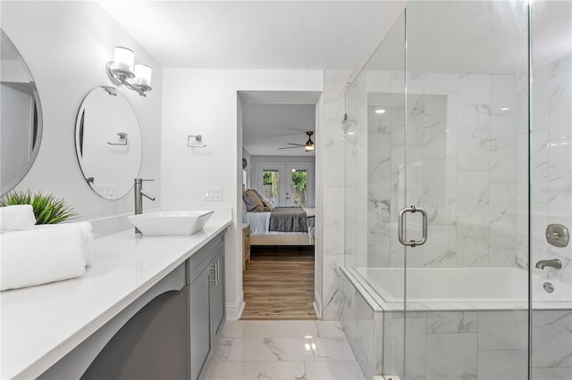 ensuite bathroom with marble finish floor, ensuite bath, a ceiling fan, and vanity