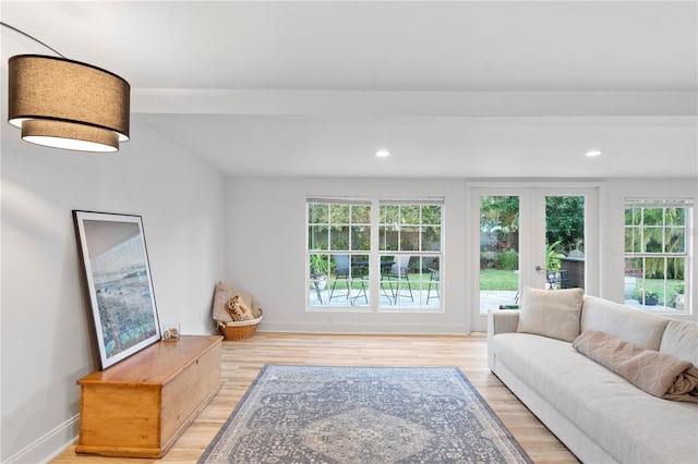 living room with light wood-type flooring, baseboards, and recessed lighting