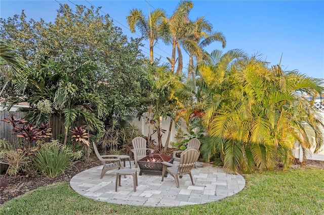 view of patio / terrace with an outdoor fire pit and fence