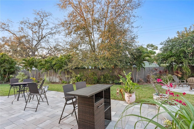 view of patio with outdoor dining area and a fenced backyard