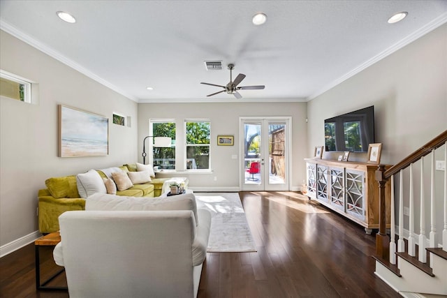 living room with crown molding, dark hardwood / wood-style floors, ceiling fan, and french doors