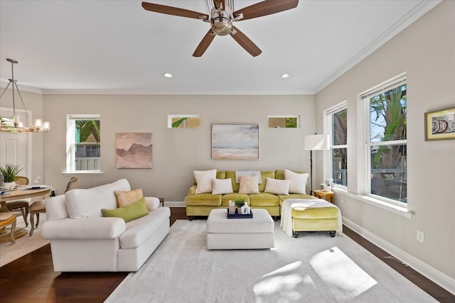 living room with crown molding, hardwood / wood-style floors, and a wealth of natural light