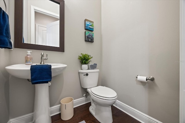 bathroom featuring hardwood / wood-style floors and toilet