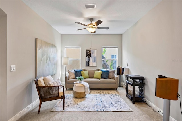 living room featuring light colored carpet and ceiling fan